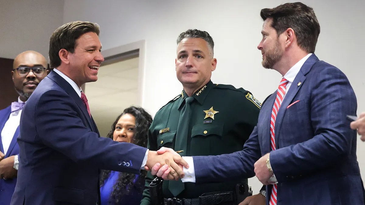 Florida Governor Ron DeSantis shakes hands with State Rep. Kevin Steele