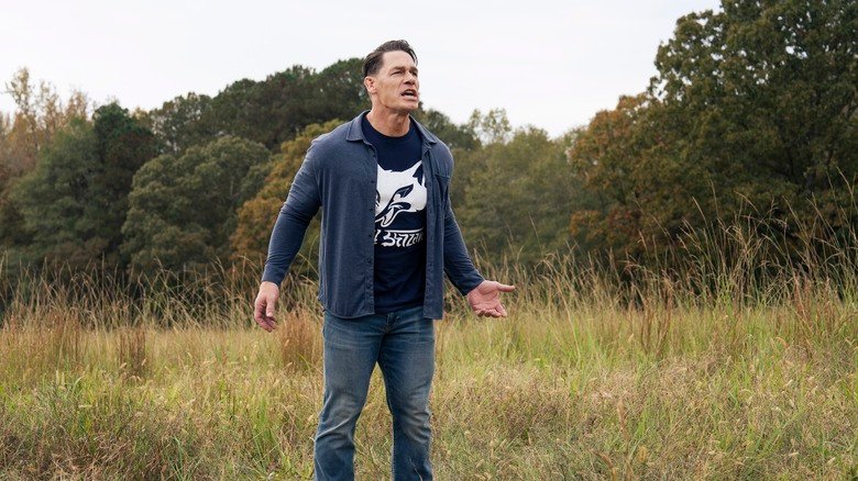 John Cena's Christopher Smith stands in a grassy field on Peacemaker