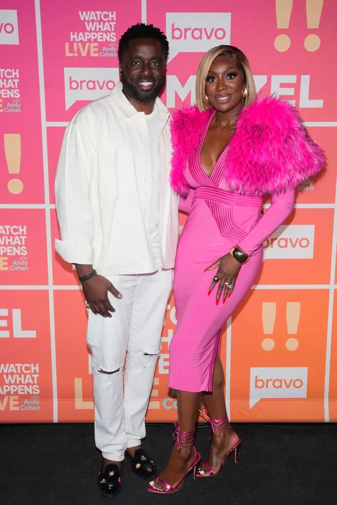 Wendy Osefo and her husband pose on the red carpet.