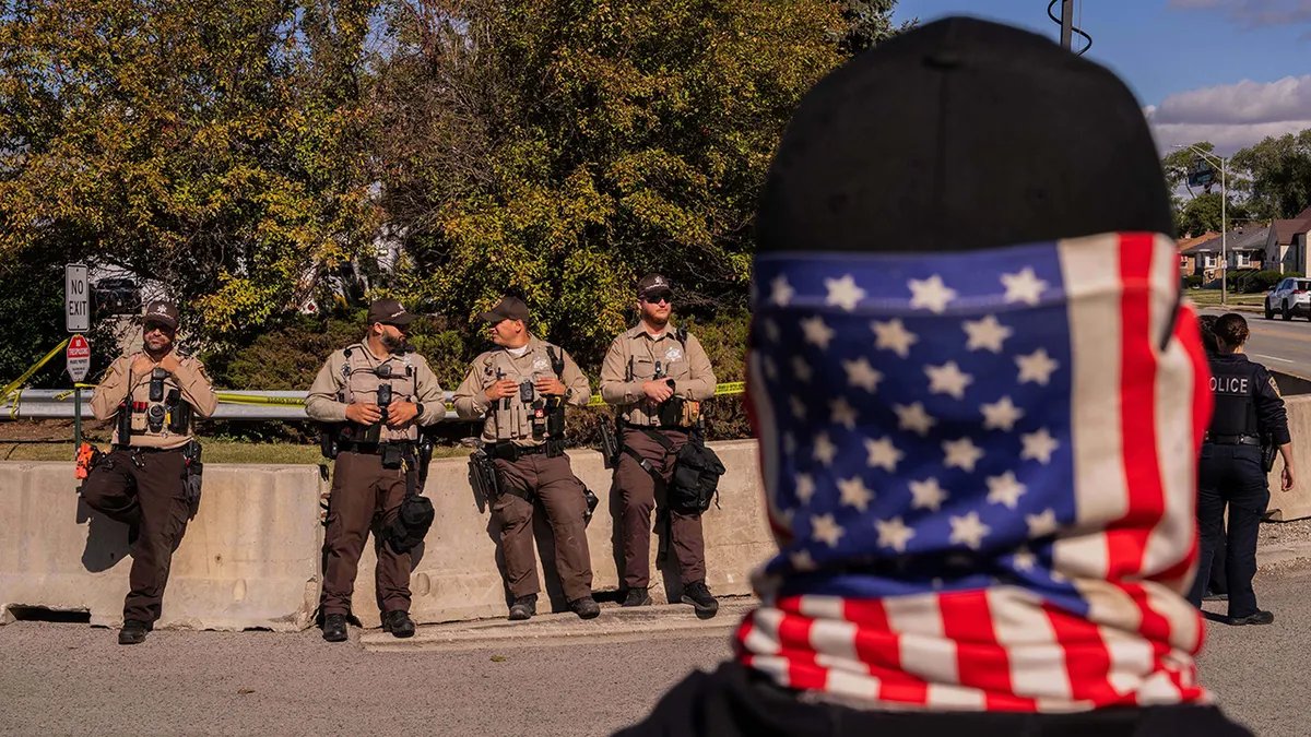 A demonstrator in front of sheriff's deputies in Chicago