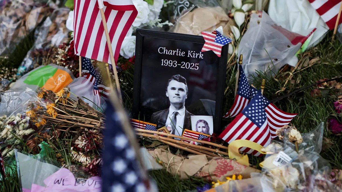 Photo of Charlie Kirk surrounded by American flags and other memorabilia