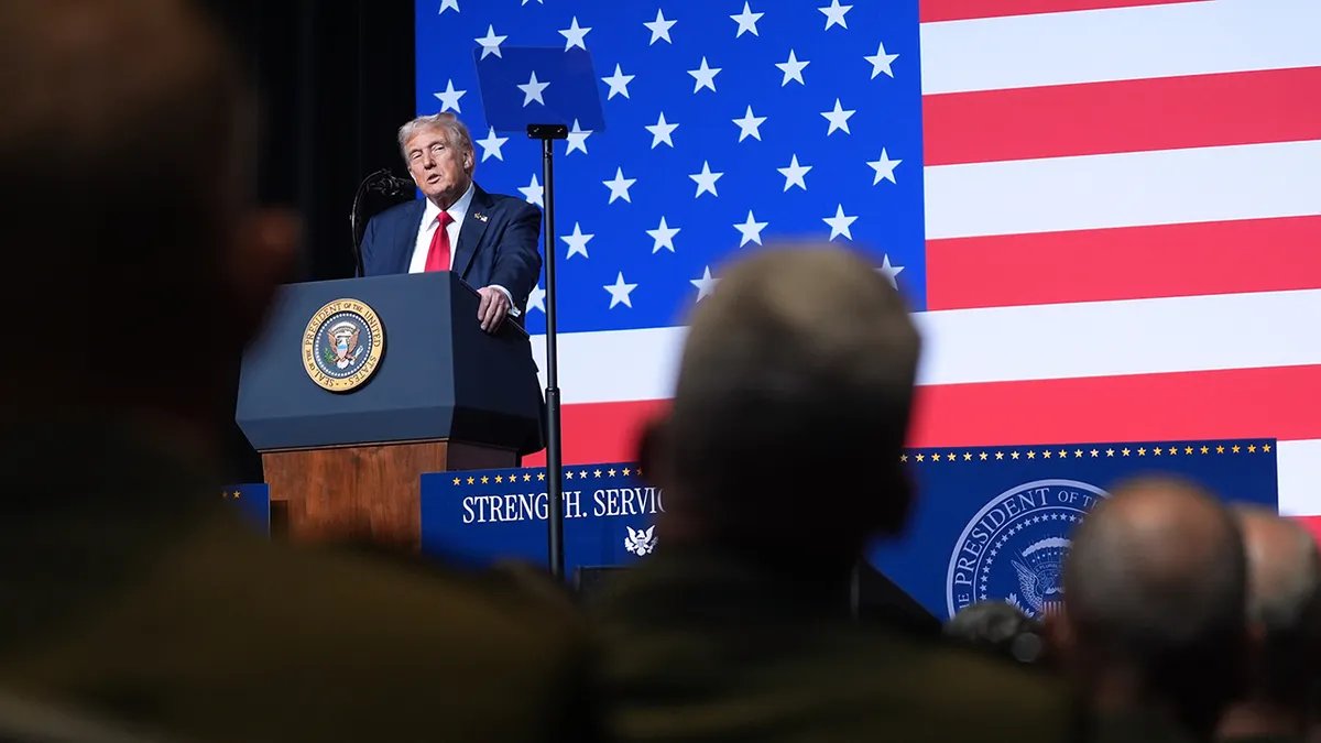 Donald Trump speaks to senior military leaders against a backdrop of the American flag