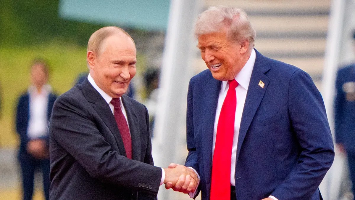 US President Donald Trump shakes hands with Russian President Vladimir Putin