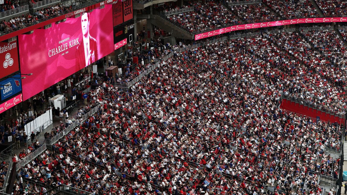 Photo of Charlie Kirk and the crowd gathered at the memorial service