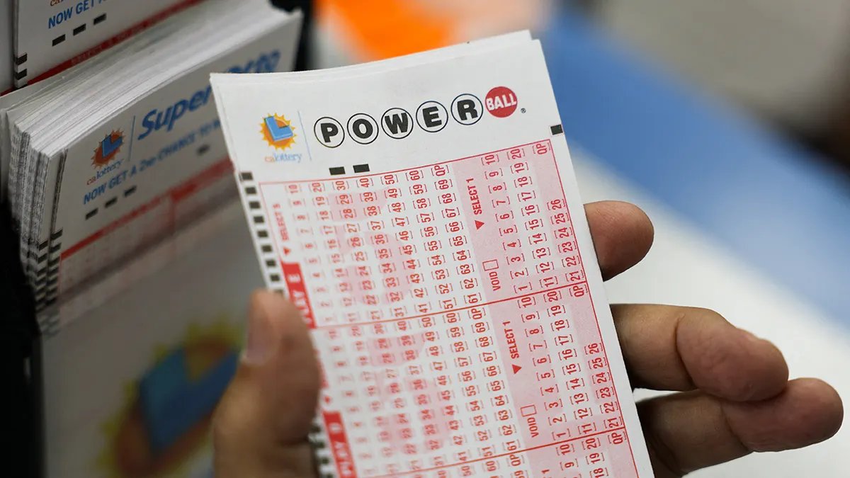 Hand holding an Arsenal lottery ticket
