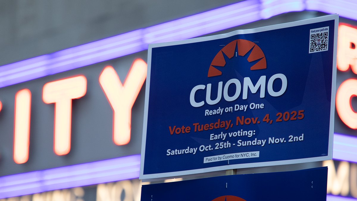 A supporter of former Gov. Andrew Cuomo holds a sign