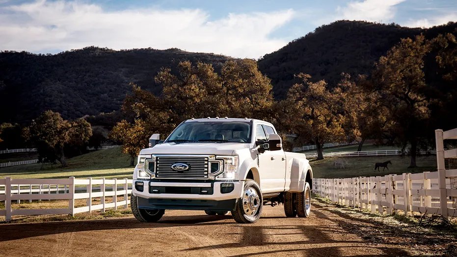 A Ford 450 performance truck is parked outside.