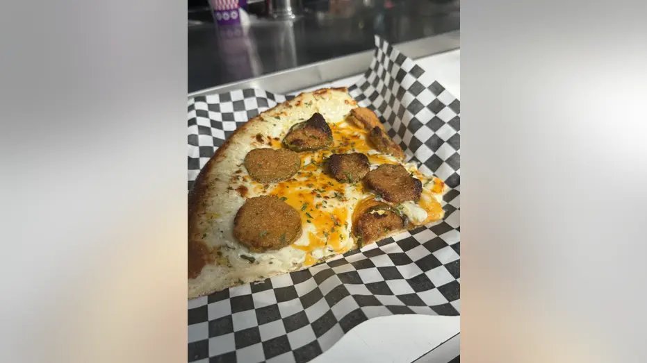 Pizza with fried pickles on a plate.
