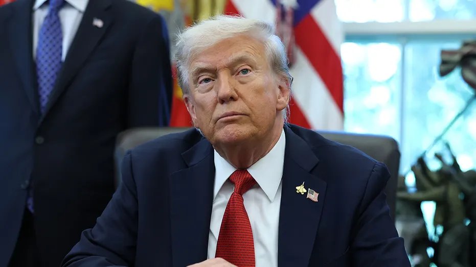 Trump sits in the Oval Office