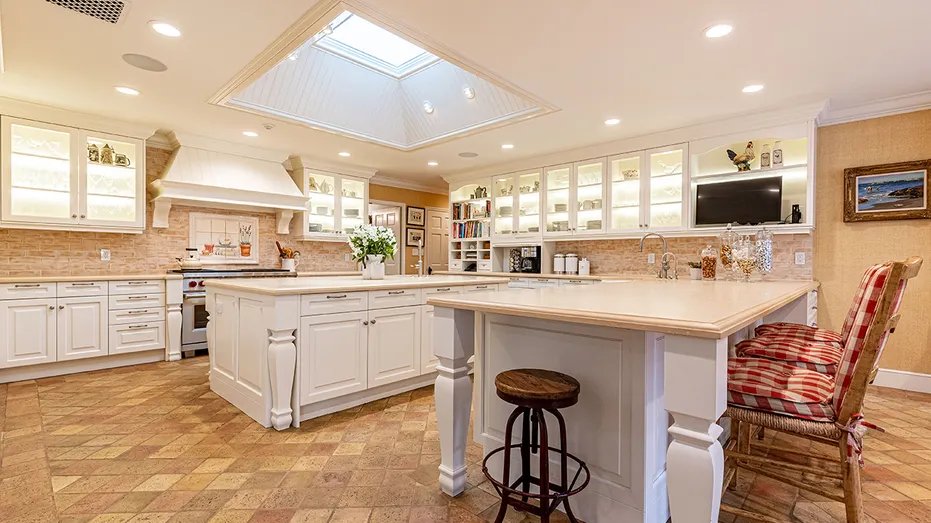 The kitchen has a large center island and an eat-in bar.