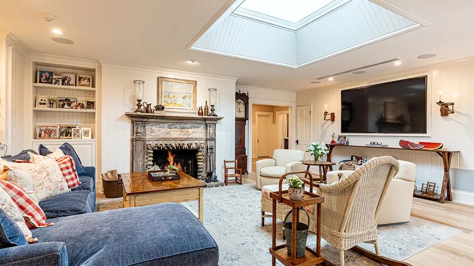 The family room has a wood-burning fireplace, TV and bookshelves.