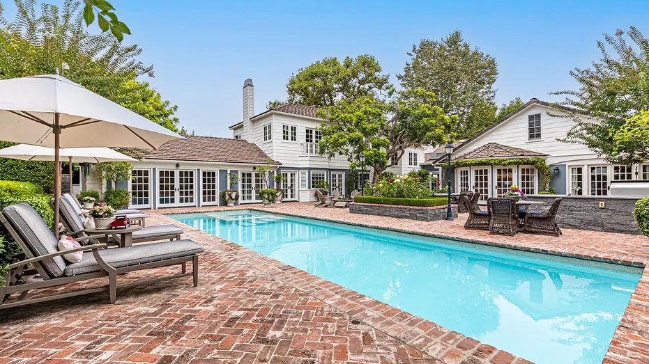 The backyard also includes a swimming pool.