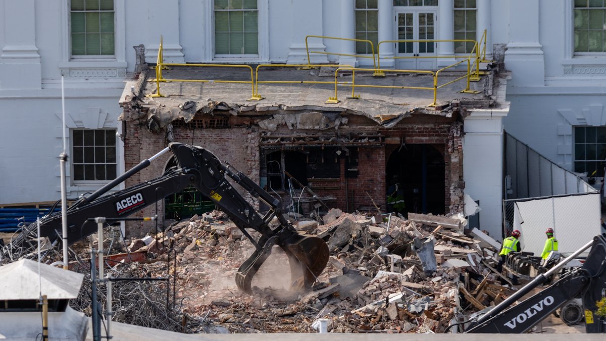 An excavator at the White House removes rubble