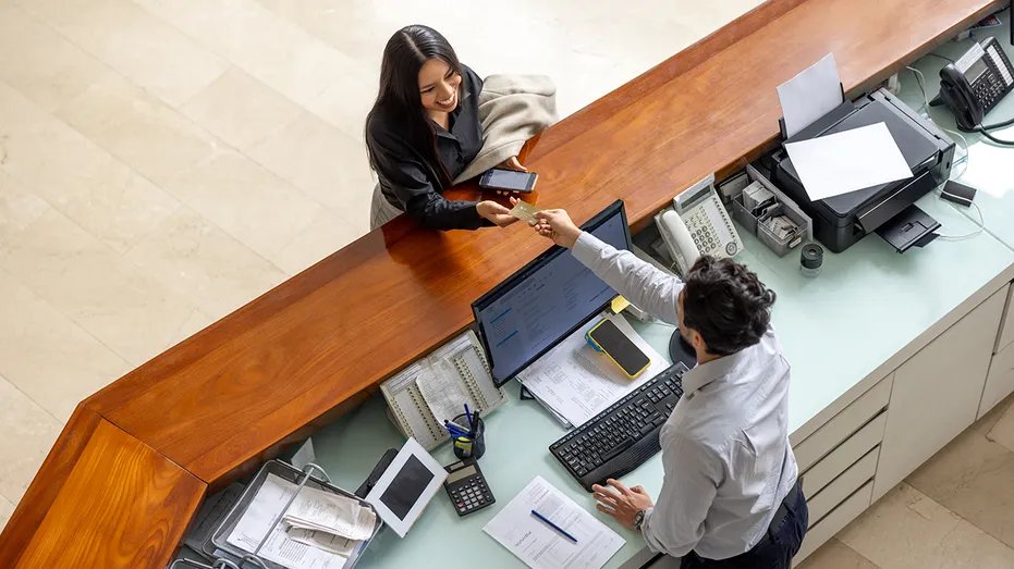 Woman paying for a hotel
