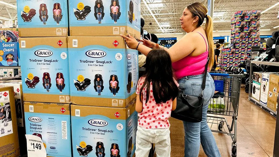 A woman shops for car seats at Walmart.