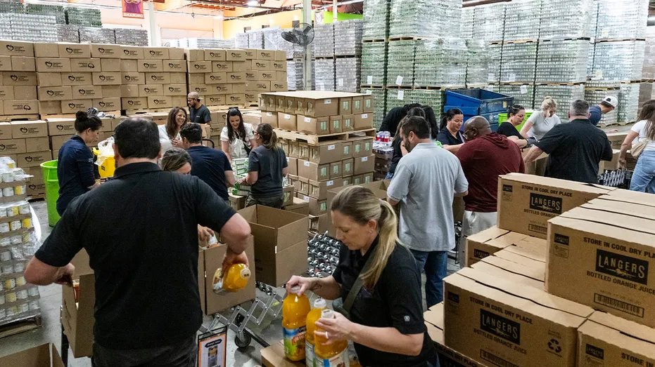 Workers pack boxes at the food bank