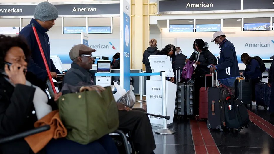 People walk through Ronald Reagan Washington National Airport.
