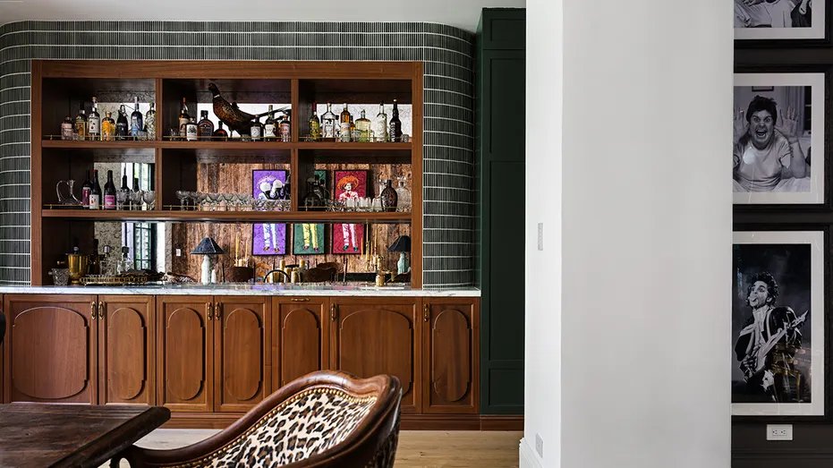 The sitting room leads into the formal dining room which also includes a bar.