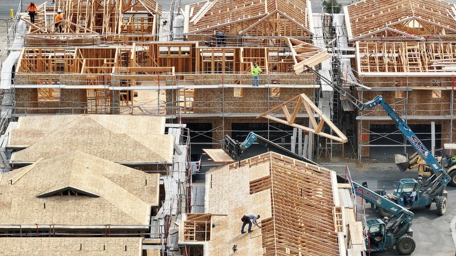 Workers are seen building homes in California.