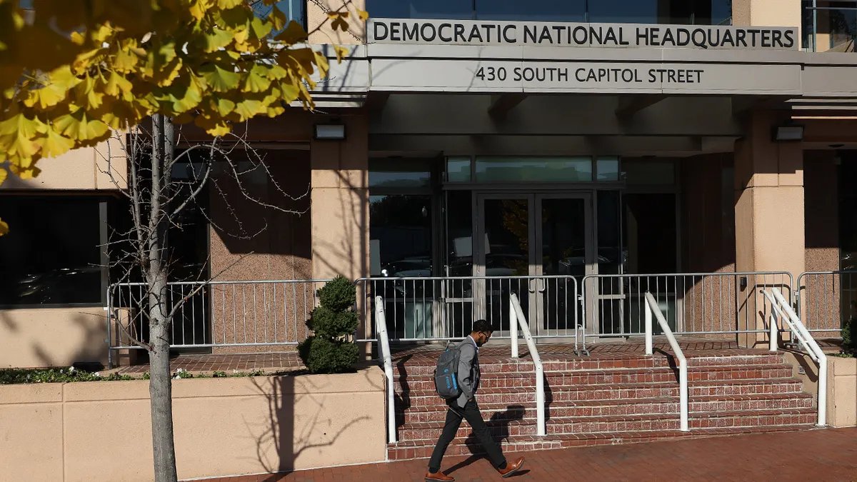 A man walks in front of the Democratic National Committee headquarters in D.C.