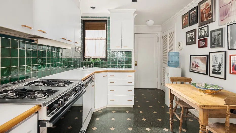 The kitchen features a green tile backsplash and a dining area.
