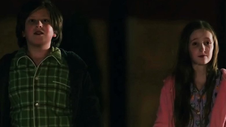 Ishak Tawfik and Tegan Sucherman as two brothers standing side by side in Pluribus