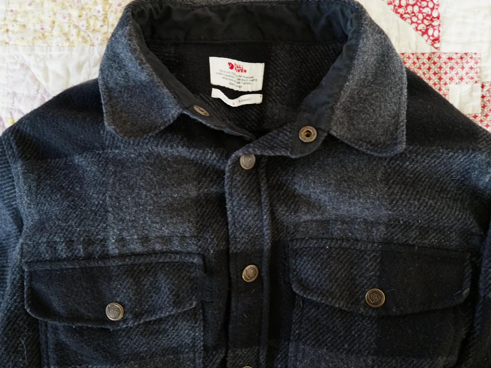 Image may contain Clothing Coat Jacket Vest Pants and Jeans