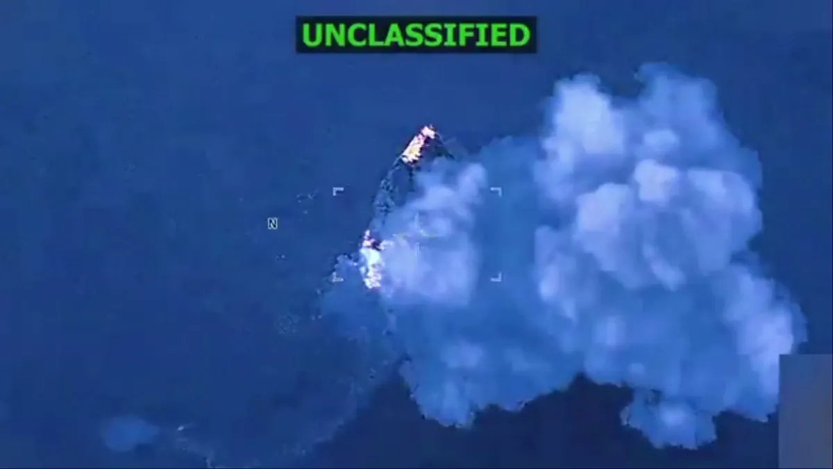 The ship burns as smoke rises into the sky