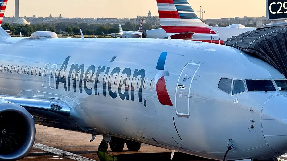 An American Airlines passenger plane is parked at the gate of Ronald Reagan Washington National Airport.