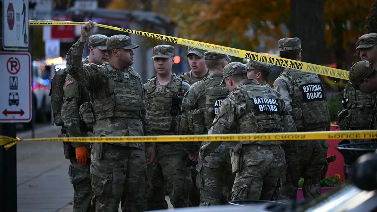 National Guard soldiers stand behind crime scene tape on a corner in downtown Washington, Nov. 26, 2025. Two National Guard soldiers were shot a few blocks from the White House, according to <a href=