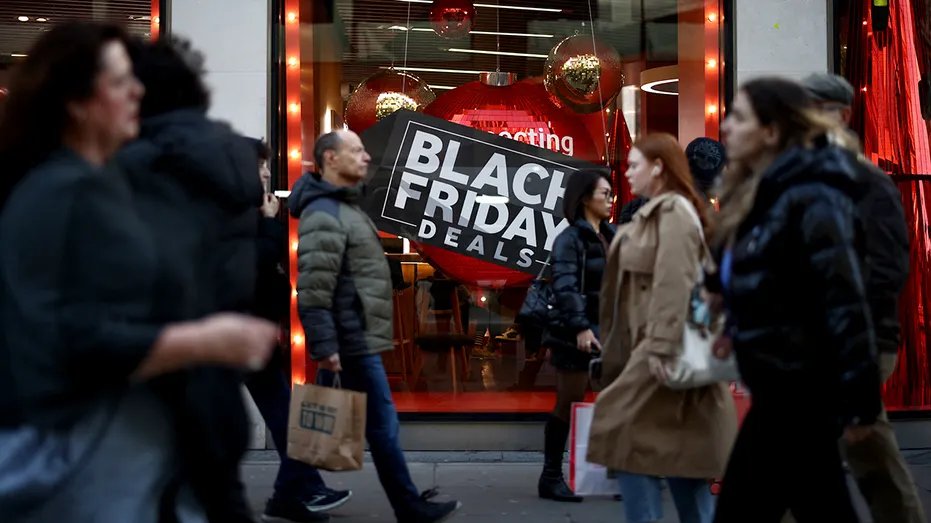 Shoppers view window scrolling Black Friday ad.