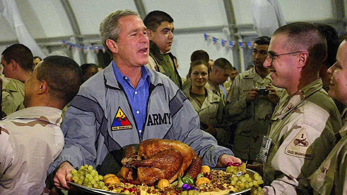 President Bush holds a turkey in Iraq