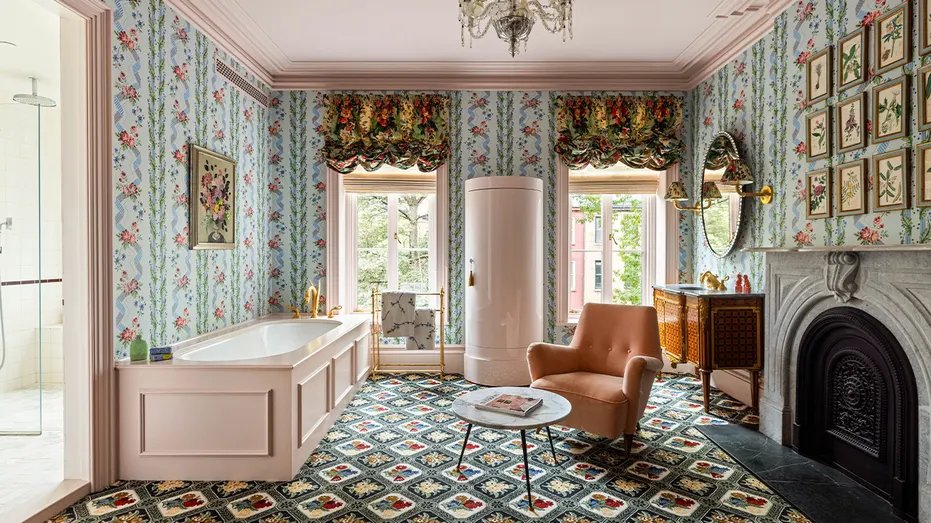 The bathroom has patterned floors and colorful wallpaper