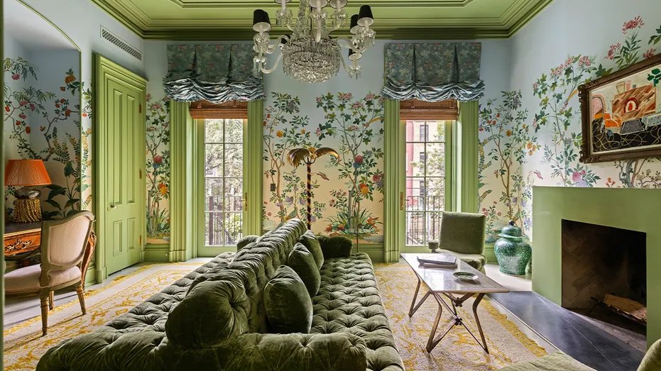 The living room has bold wallpaper and a statement chandelier