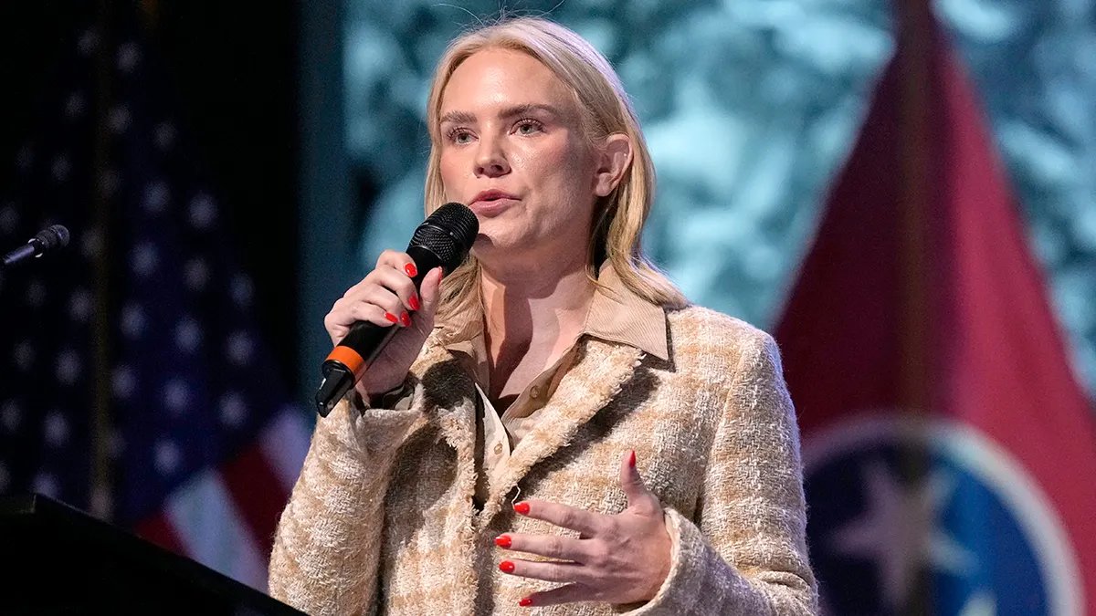 Tennessee Democratic candidate Aftin Behn holds a microphone.