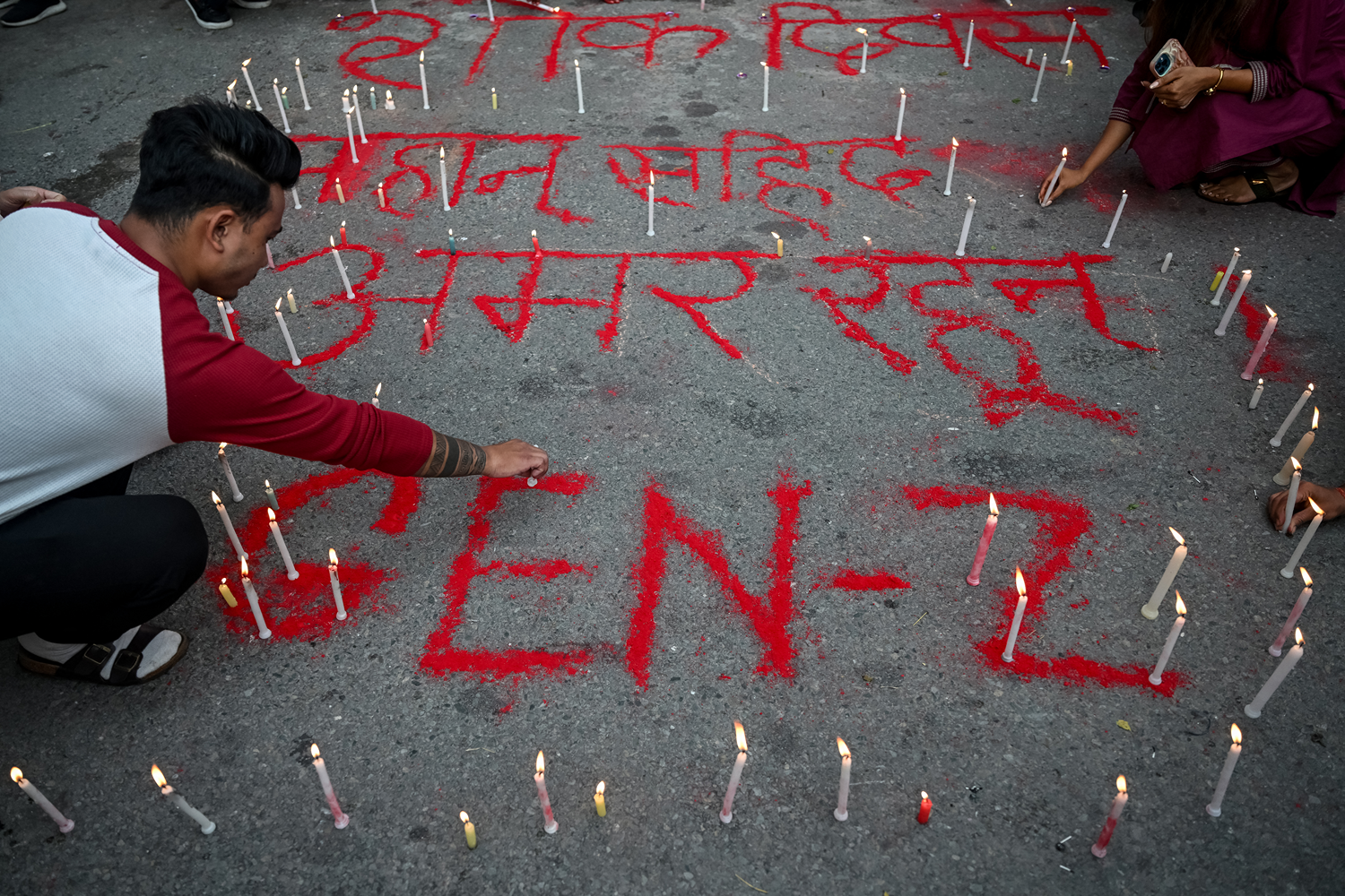 People light candles during a silent tribute in honor of those killed during the recent Generation Z protests at the Maityagar Mandala Memorial in Kathmandu, Nepal, on September 17.