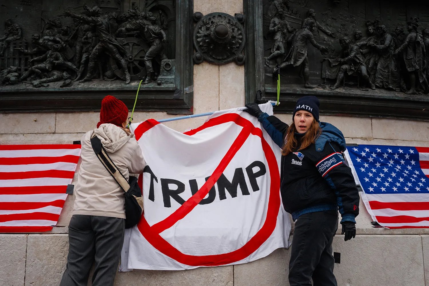 U.S. citizens living in France hold up a banner during a protest against Trump in Paris.