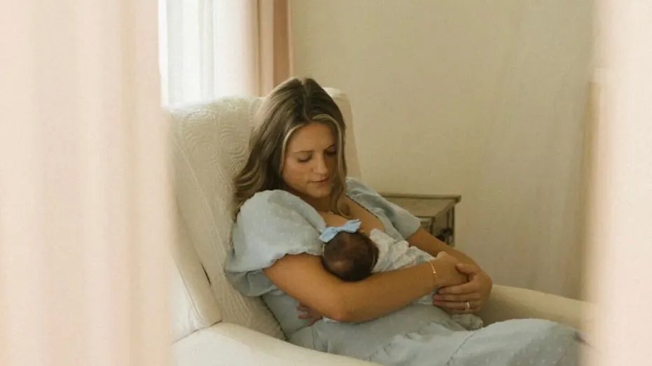 Aris Kubik holds his newborn daughter