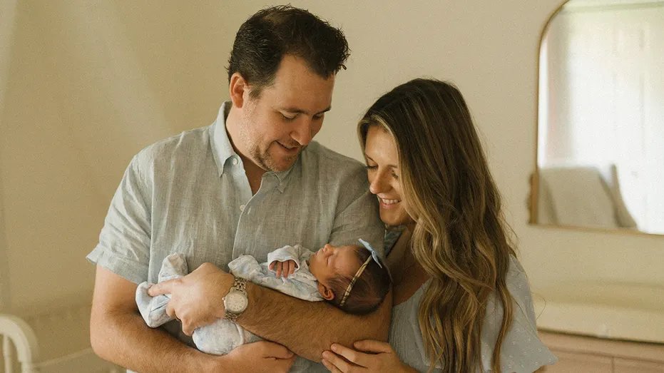 Mr. and Mrs. Kubik hold their newborn daughter.