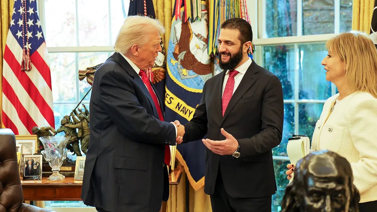Trump shakes hands with Ahmed Al-Sharaa