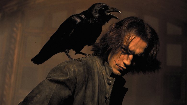Ash Corvin with a crow on his shoulder in a movie 