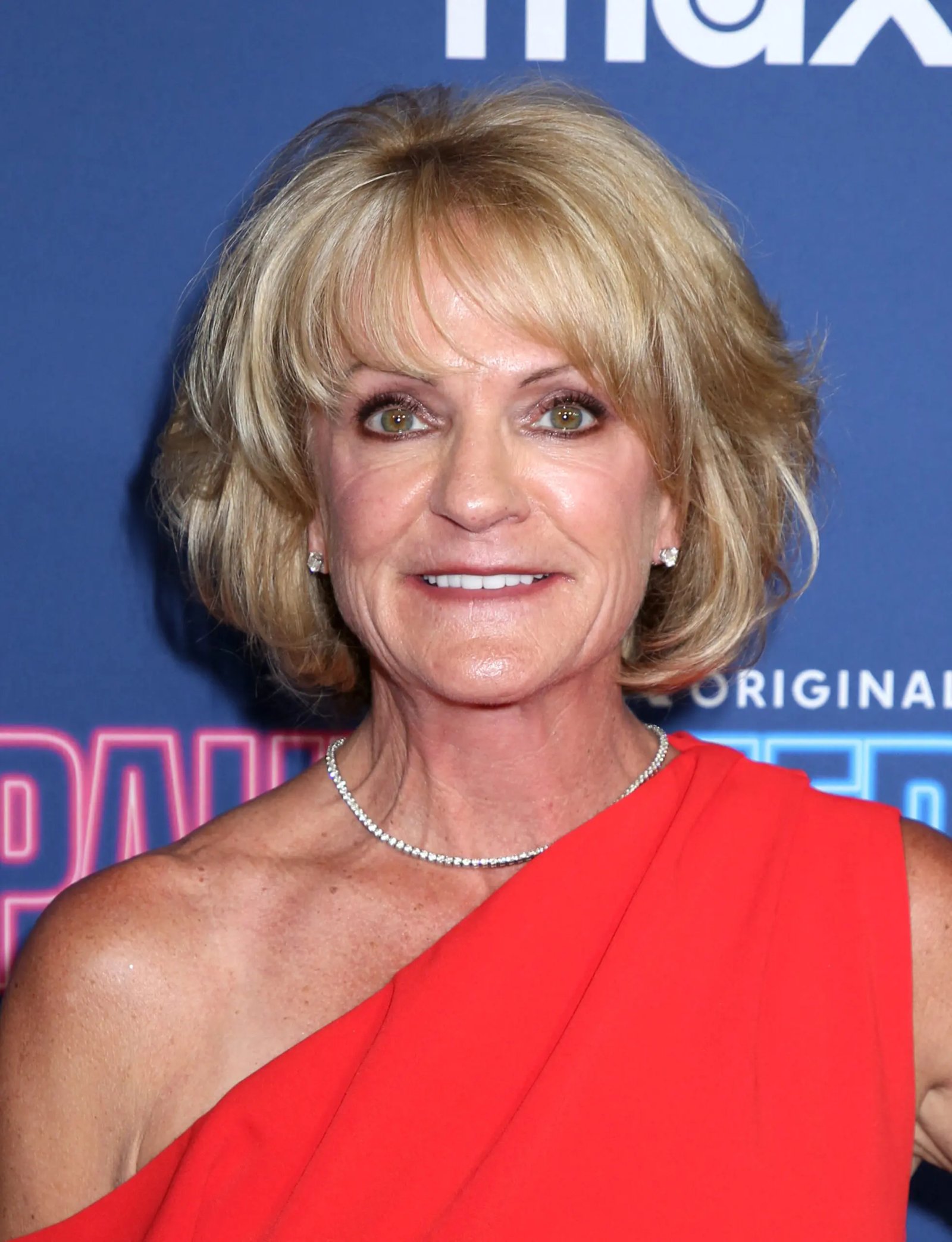 Logan's mother and Jake Paul pose on the red carpet. 