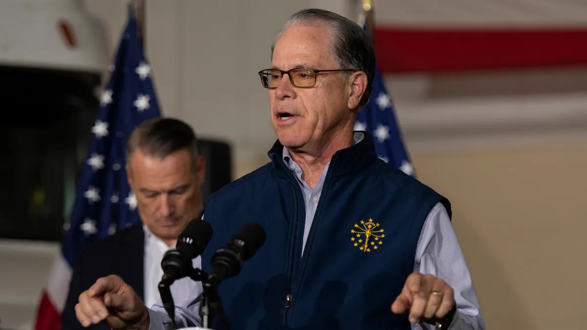 Governor Mike Brown speaks at the podium