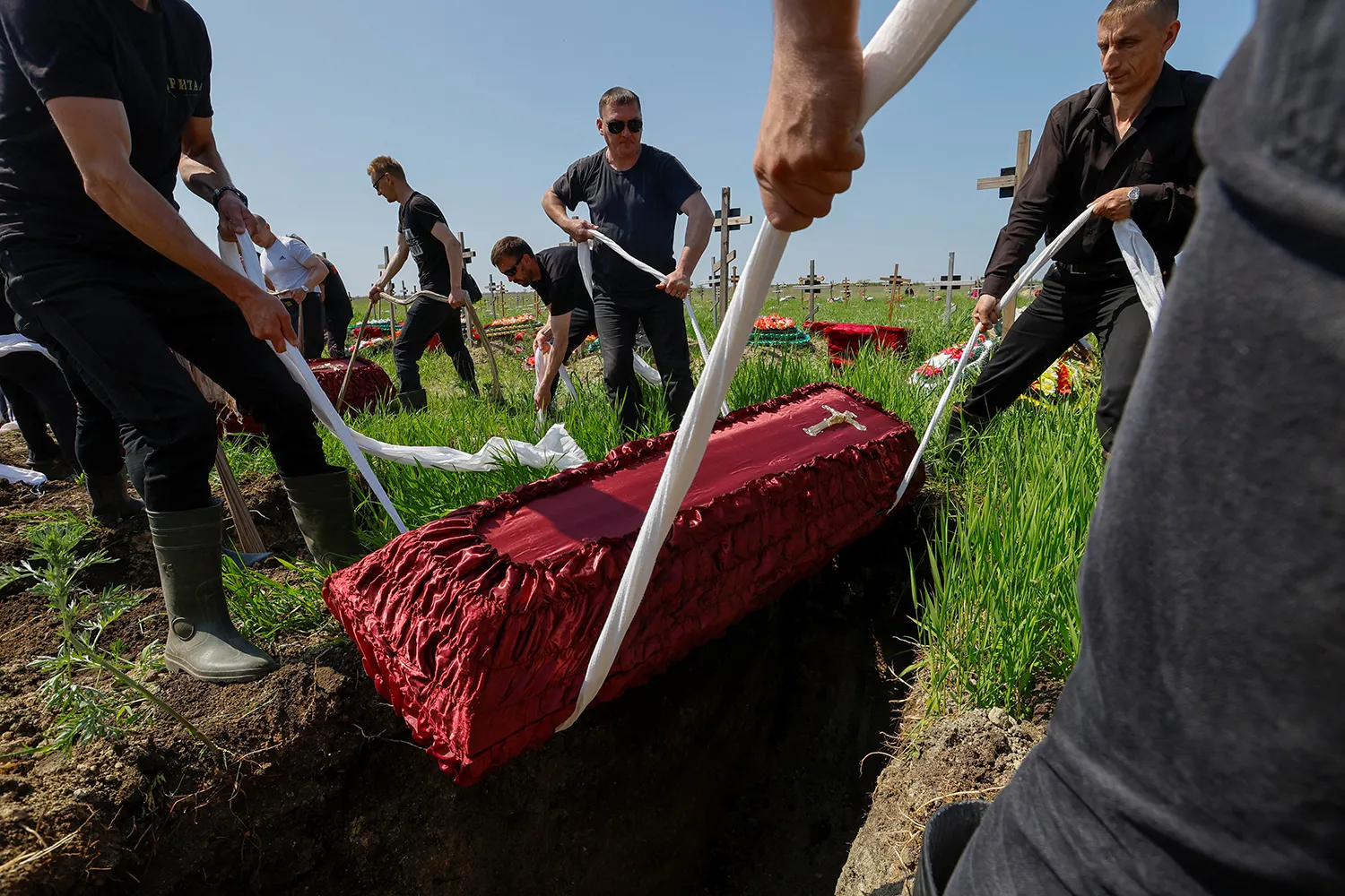 People take part in a funeral ceremony to bury the remains of service members of the Russian Armed Forces in Luhansk, in Russian-controlled Ukraine.