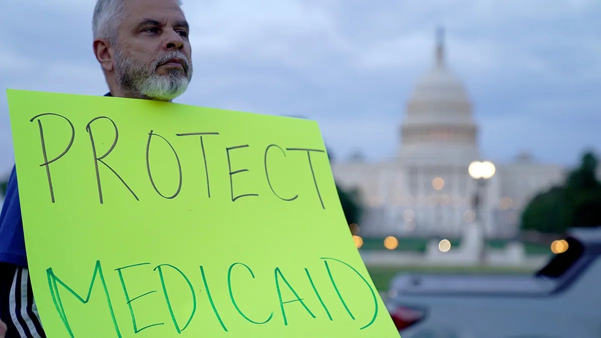 A protester holds a sign amid the government shutdown this year