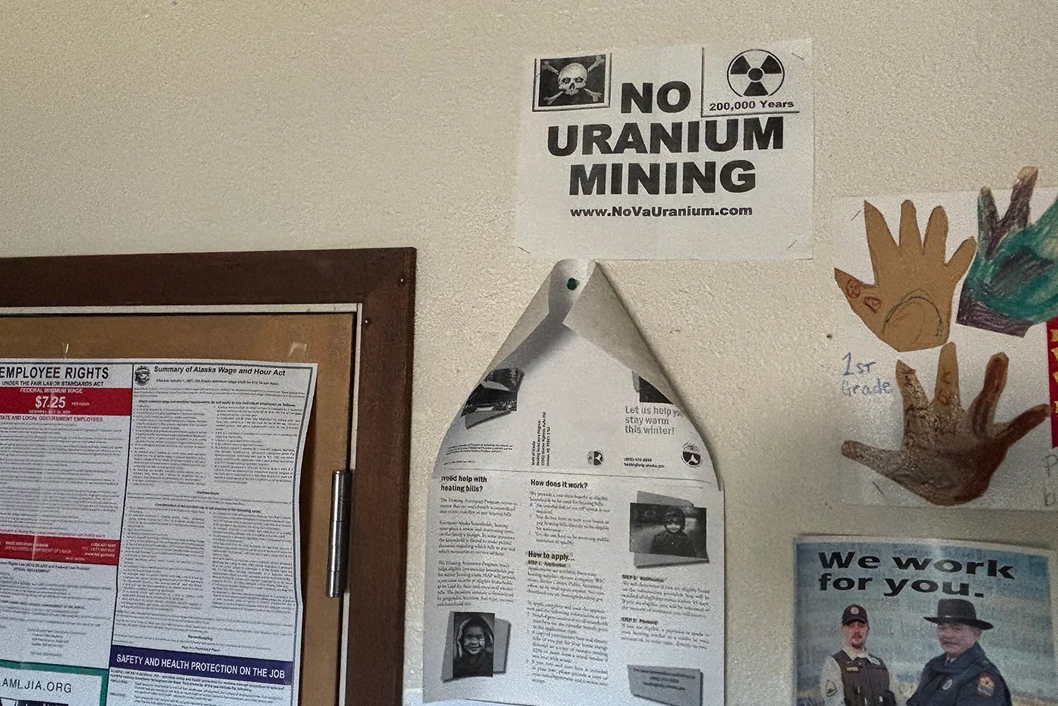 Signs on the wall, including one with a skull and crossbones and a nuclear sign that says "There is no uranium mining."