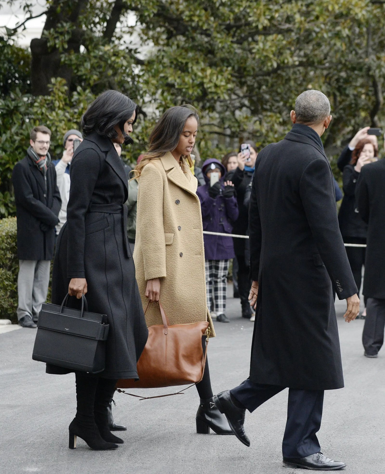 President of the United States Barack Obama with First Lady Michelle Obama and daughter Malia walk on the South Lawn toward Marine One to leave the White House in Washington, D.C. January 10, 2017 Pictured: Michelle Obama, Malia Obama, Barack Obama. Photo Source: ZUMA Press / MEGA TheMegaAgency.com +1 888 505 6342 (Mega Agency TagID: MEGA10568_003.jpg) [Photo via Mega Agency]