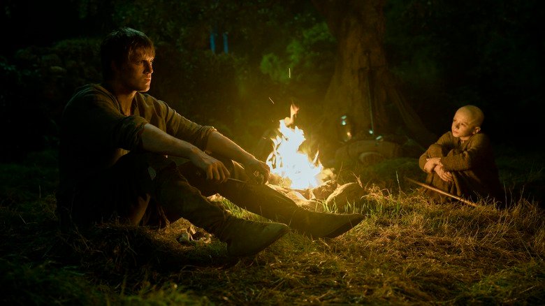 Peter Claffey as Ser Duncan the Tall sits by a campfire opposite Dexter Saul Ansell as Egg in A Knight of the Seven Kingdoms