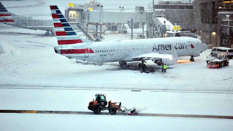 American Airlines planes at snowy LaGuardia Airport