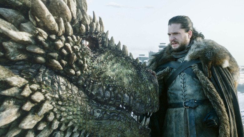 Jon Snow standing next to a dragon in Game of Thrones